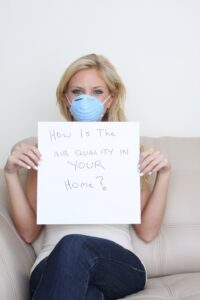 woman-holding-sign-asking-about-indoor-air-quality