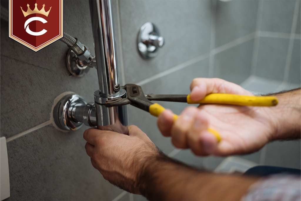 Plumber repairing at a stainless steel pipe